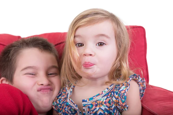 Young brother and sister pulling faces — Stock Photo, Image