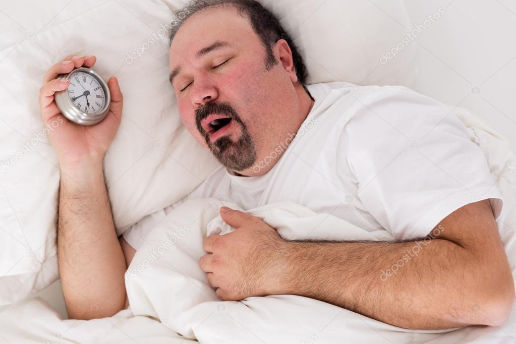 Lethargic man yawning as he struggles to wake up