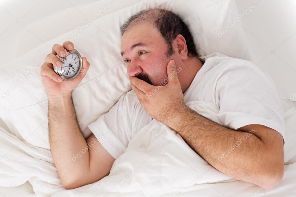 Man suffering from insomnia trying to sleep