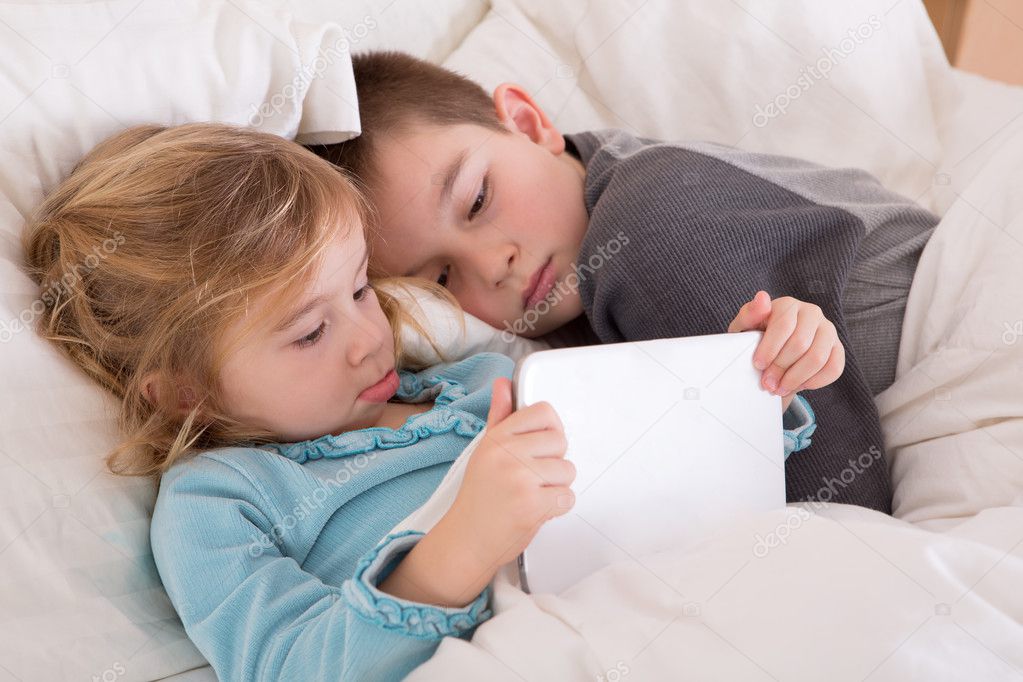 Cute little girl and boy reading a bedtime story