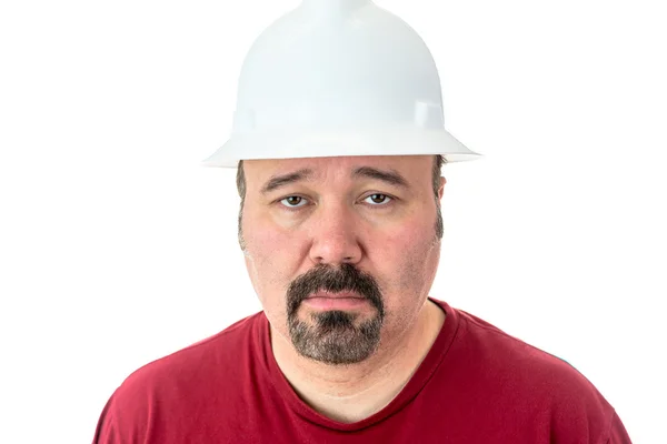 Morose glum looking man in a hardhat — Stock Photo, Image