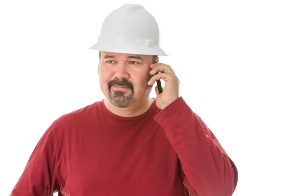 Bored looking workman chatting on his mobile — Stock Photo, Image