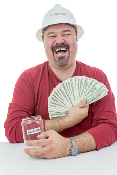 Bouwvakker lachen met vakanties geld — Stockfoto