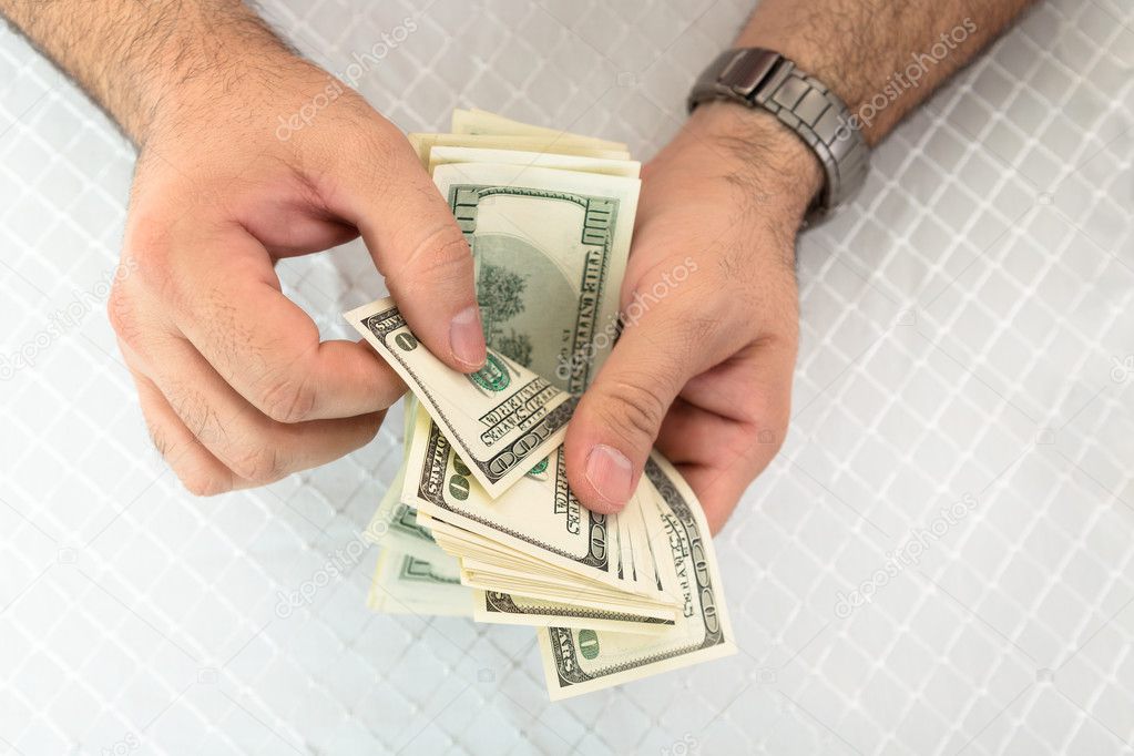 Man counting dollar notes