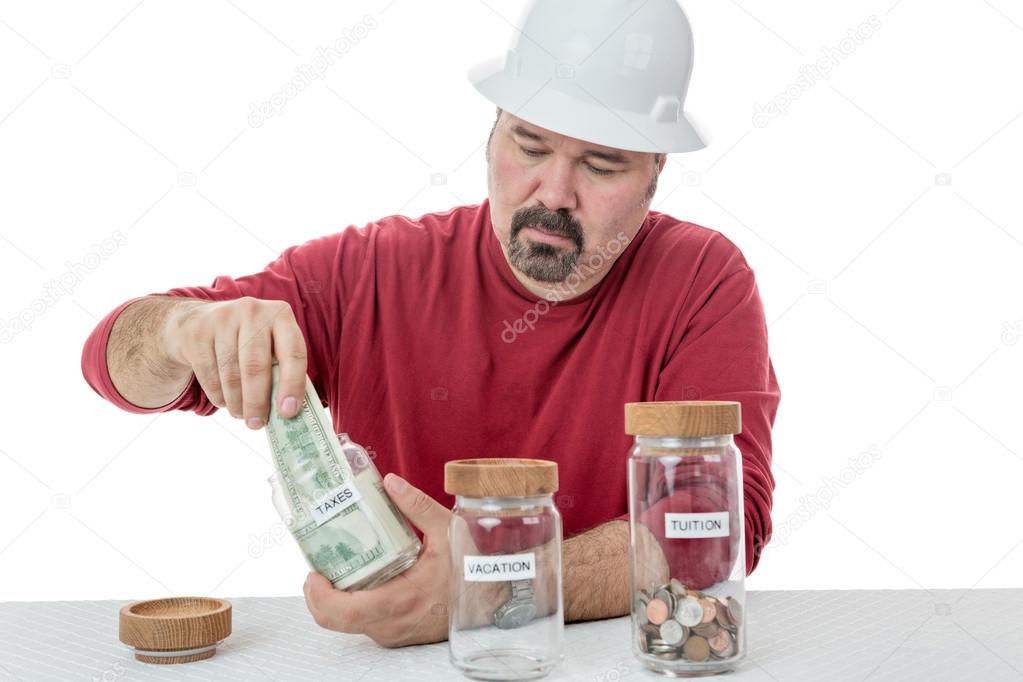 Unhappy construction worker paying the taxes