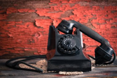 Old-fashioned rotary telephone off the hook clipart