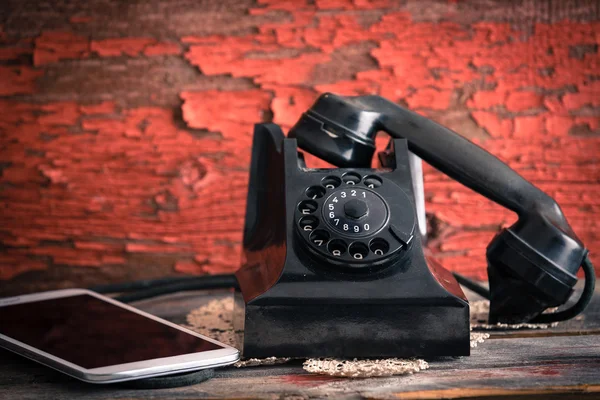 Teléfono giratorio antiguo junto a una tableta —  Fotos de Stock