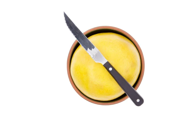 Kitchen knife on a ripe yellow grapefruit — Stock Photo, Image