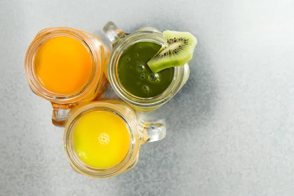 Three jugs of fresh tropical fruit juice — Stock Photo, Image