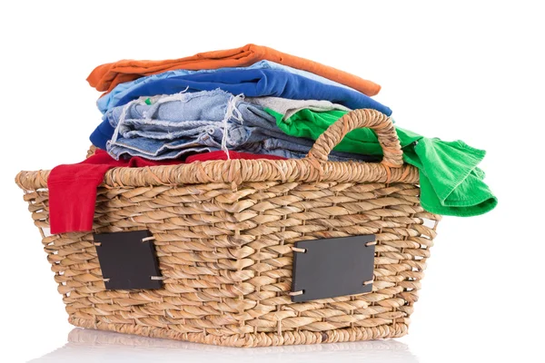 Clean washed fresh clothing in a wicker basket — Stock Photo, Image