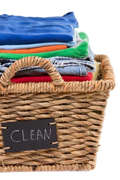 Washed fresh clean clothes in a laundry basket — Stock Photo, Image