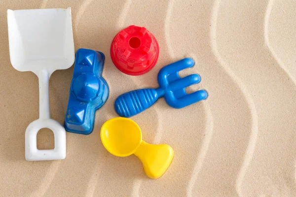 Colorful kids plastic toys at the beach — Stock Photo, Image