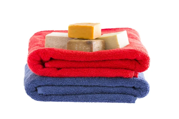 Neatly folded cotton towels with soap — Stock Photo, Image