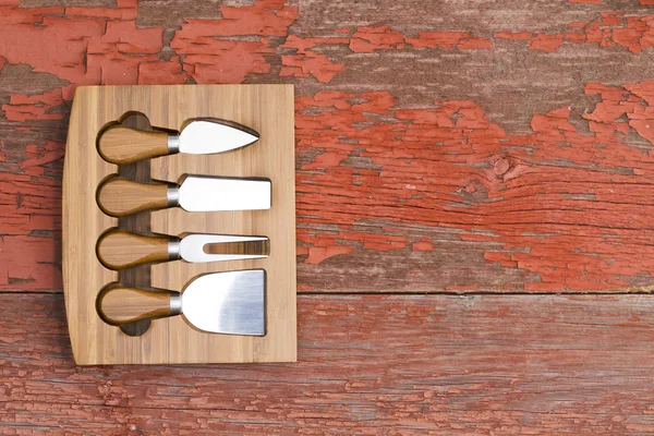 Set of cheese cutters in a fitted wooden block — Stock Photo, Image