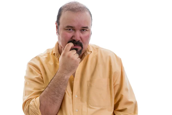 Thoughtful man chewing his finger as he debates — Stock Photo, Image