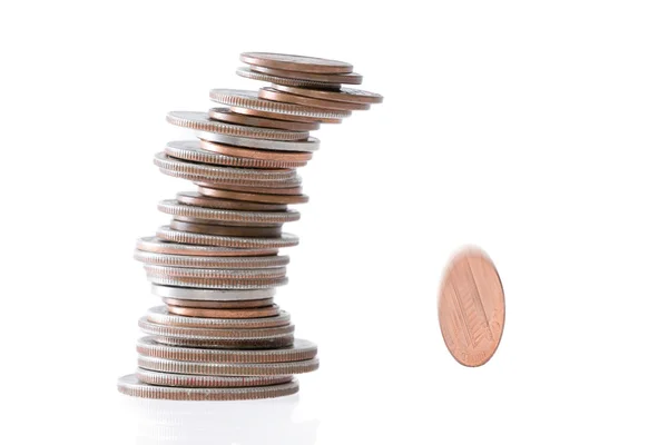 Precarious stack of coins falling — Stock Photo, Image