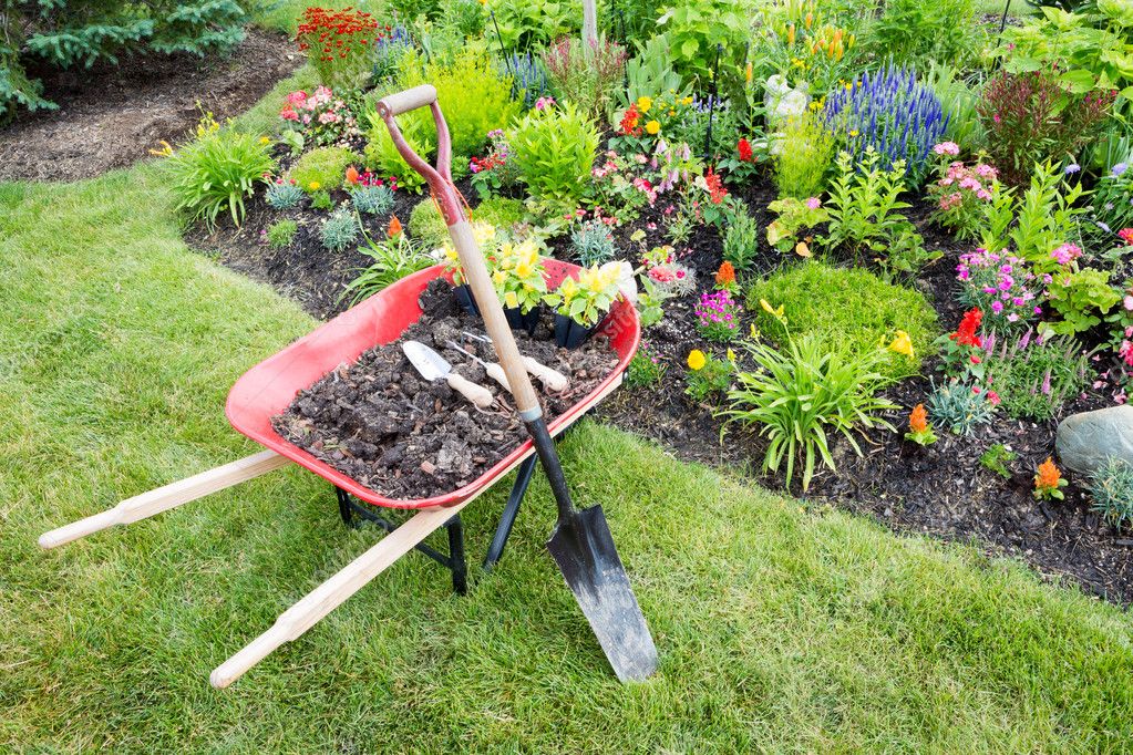 Garden work being done landscaping a flowerbed Stock Photo by ©oocoskun  48057203
