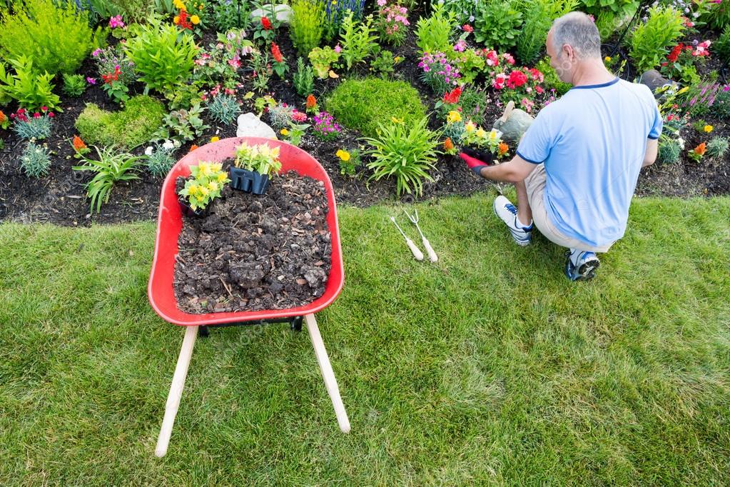 Gardener landscaping a garden — Stock Photo © oocoskun 48057671
