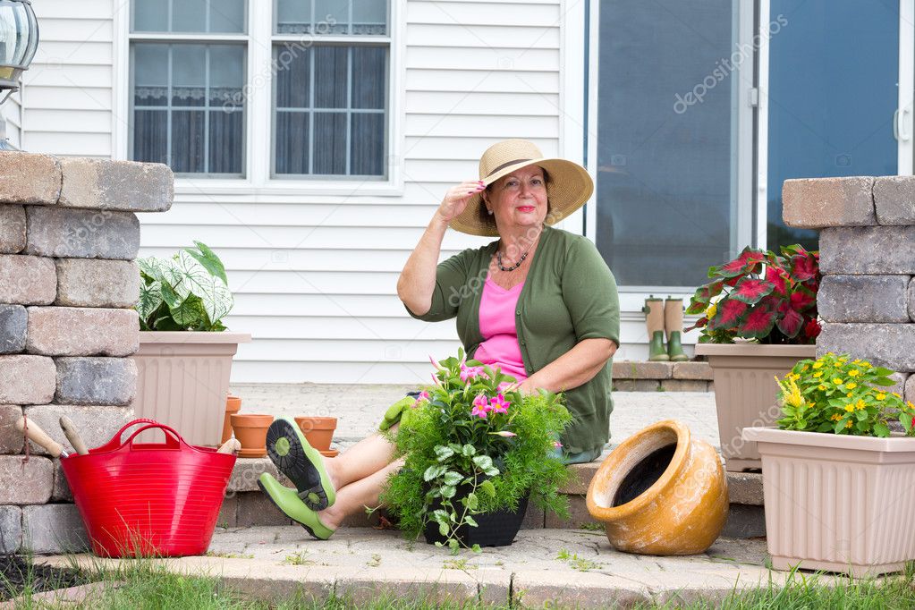 Elegant Grandma posing as she pots up plants