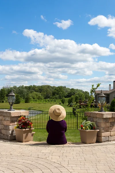 Grandma gardener taking a break to admire the view — Stock Photo, Image