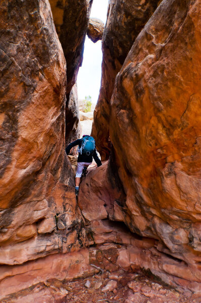 Hiker under boulder