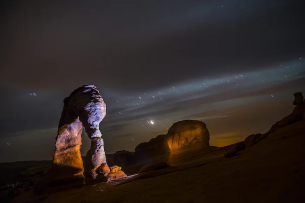 Delicate Arch at Night against Beautiful night sky Stock Photo