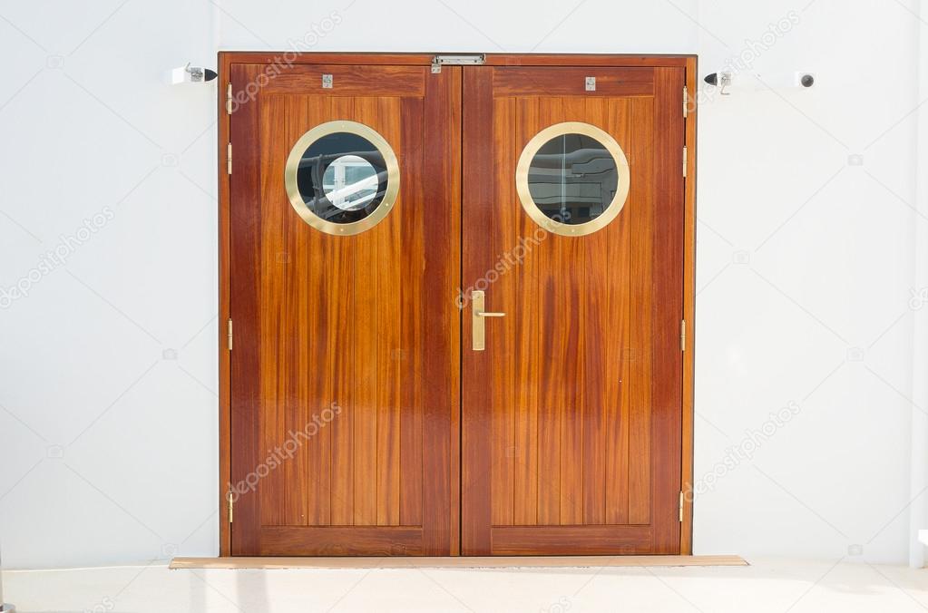 Closed wooden dobule doors with brass fittings