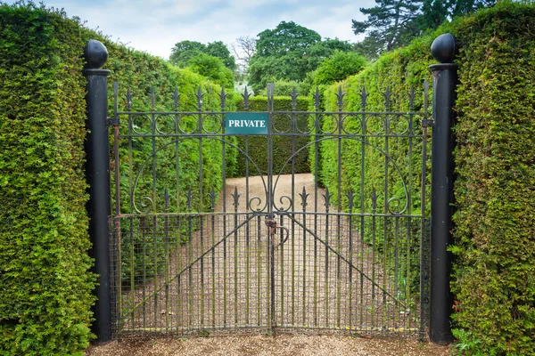 Private sign attached to an ornate wrought iron gate — Stock Photo, Image