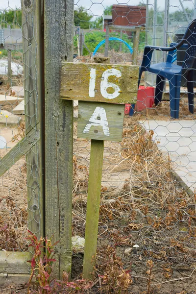 Wooden sign giving garden plot number — Stock Photo, Image