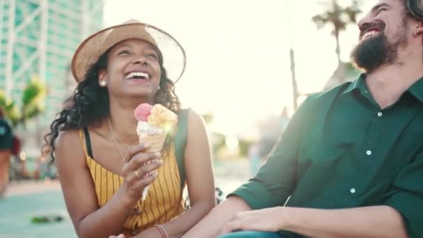 在城市背景下 一对快乐的跨种族夫妇正在吃冰淇淋 一个尝冰淇淋的男人和女人的特写镜头 — 图库视频影像