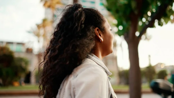 Closeup, woman walking smiling holding hands. Close-up of female going on a city street