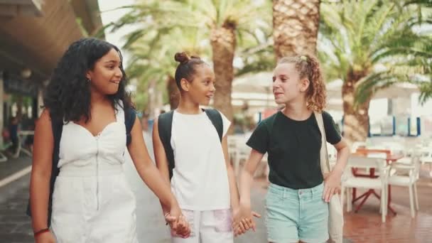 三个十几岁前的女朋友牵着手在街上笑着 谈情说爱 三个在城市景观背景下的户外青少年 — 图库视频影像
