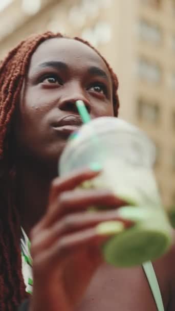 Vertical Video Beautiful Woman African Braids Walks Street Cold Drink — Vídeos de Stock