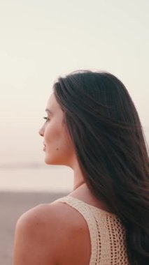 VERTICAL VIDEO: Profile Beautiful brown-haired woman with long hair. Gorgeous girl with freckles and long eyelashes. slow motion