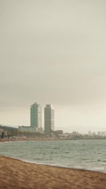 VERTICAL VIDEO: Coastal seascape on modern high rise buildings background