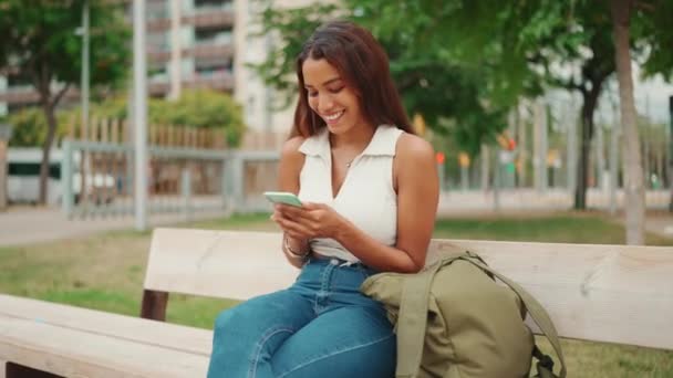 Beautiful Girl Long Dark Hair Wearing White Top Sits Bench — Vídeo de stock