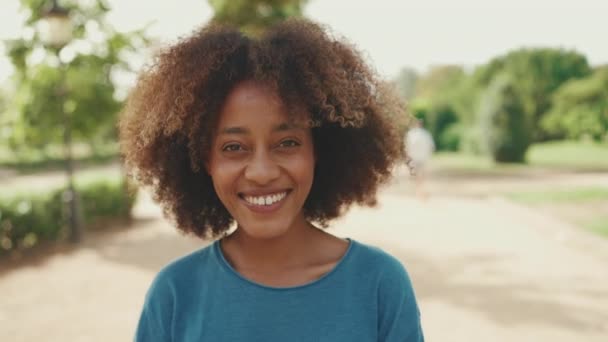 Close Young Smiling Woman Curly Hair Wearing Blue Shirt Posing — Stockvideo