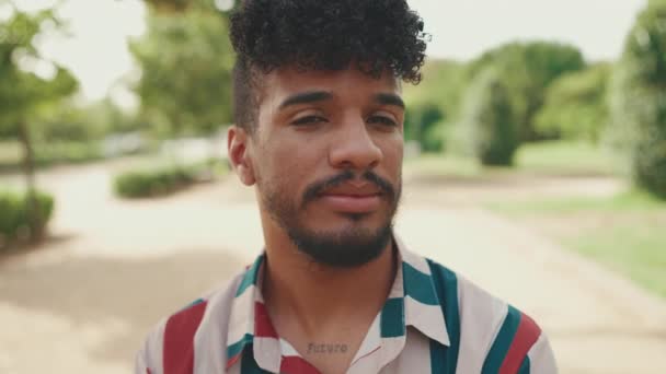 Close Young Man Curly Hair Wearing Striped Shirt Looking Camera — Stock Video