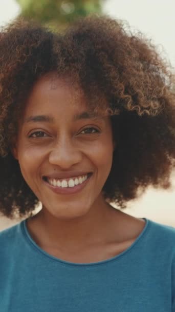 Vertical Video Close Young Smiling Woman Curly Hair Wearing Blue — Vídeo de Stock