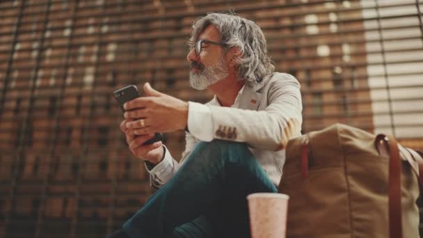 Mature Businessman Beard Eyeglasses Wearing Gray Jacket Holds Cellphone His — Stockvideo