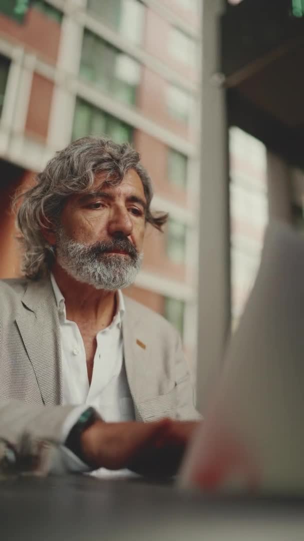 Vertical Video Mature Businessman Beard Wearing Gray Jacket Sits Cafe — Vídeos de Stock