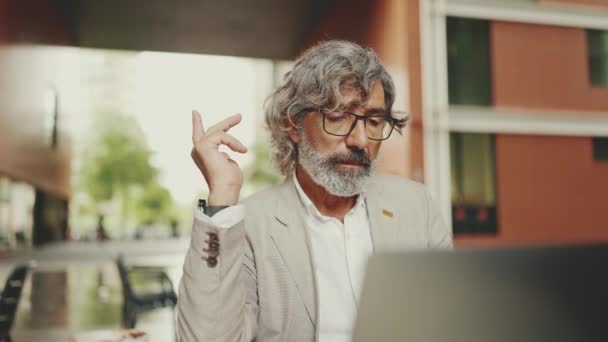 Mature Businessman Beard Eyeglasses Wearing Gray Jacket Sits Cafe Middle — стоковое видео