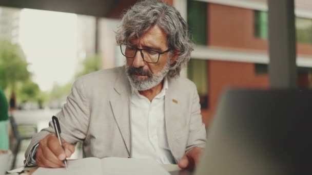 Mature Businessman Beard Eyeglasses User Laptop Computer Taking Notes Sitting — Stockvideo