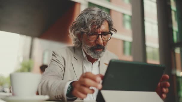 Mature Businessman Beard Eyeglasses Wearing Gray Jacket Working Tablet Sitting — Video Stock