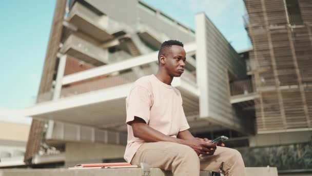 Young African Student Sits University Uses Cellphone — Vídeos de Stock