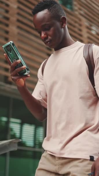 Vertical Video Young African Student Walks Stairs University Using Cellphone — 图库视频影像