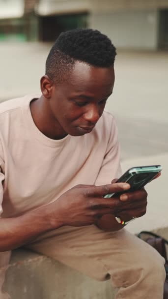 Vertical Video Young African Student Sits University Uses Cellphone Writes — Wideo stockowe