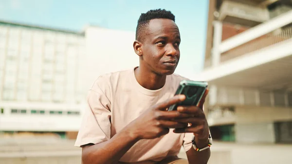 Young African Student Sits University Uses Cellphone Taps Smartphone Screen — Stockfoto