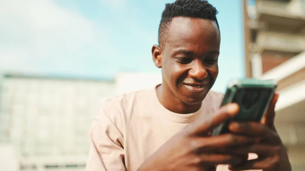 Young African Student Sits University Uses Cellphone Taps Smartphone Screen — Stockfoto