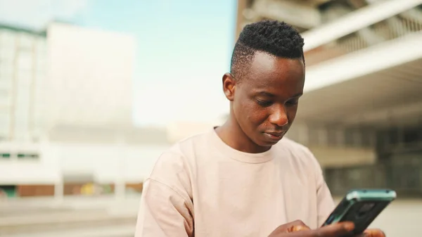 Young African Student Sits University Uses Cellphone Taps Smartphone Screen — Stockfoto